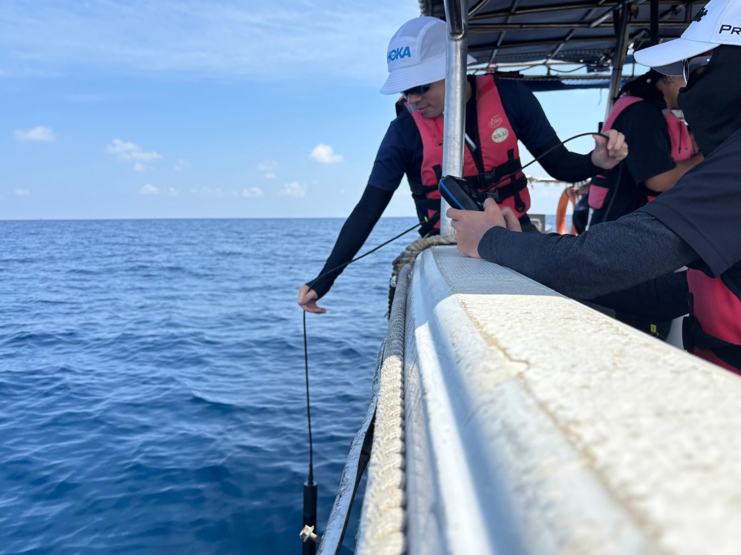 PPI personnel collecting water samples at sea